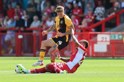 080825 - Crawley Town v Newport County, EFL Sky Bet League 2 - Kai Whitmore of Newport County is challenged by Jay Williams of Crawley Town