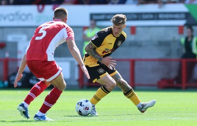 080825 - Crawley Town v Newport County, EFL Sky Bet League 2 - Kai Whitmore of Newport County takes on Charlie Barker of Crawley Town