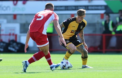 080825 - Crawley Town v Newport County, EFL Sky Bet League 2 - Kai Whitmore of Newport County takes on Charlie Barker of Crawley Town