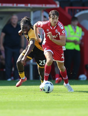 080825 - Crawley Town v Newport County, EFL Sky Bet League 2 - Josh Flint of Crawley Town and Michael Reindorf of Newport County compete for the ball