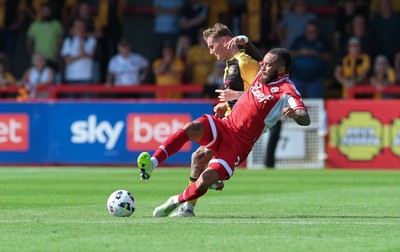 080825 - Crawley Town v Newport County, EFL Sky Bet League 2 - Kai Whitmore of Newport County is tackled by Jay Williams of Crawley Town