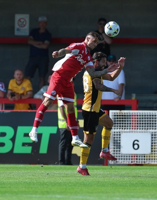080825 - Crawley Town v Newport County, EFL Sky Bet League 2 - Gavan Holohan of Crawley Town gets above Liam Shephard of Newport County to head forward