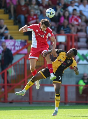 080825 - Crawley Town v Newport County, EFL Sky Bet League 2 - Josh Flint of Crawley Town and Bobby Kamwa of Newport County compete for the ball