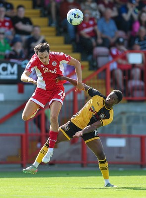 080825 - Crawley Town v Newport County, EFL Sky Bet League 2 - Josh Flint of Crawley Town and Bobby Kamwa of Newport County compete for the ball