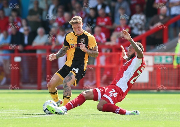 080825 - Crawley Town v Newport County, EFL Sky Bet League 2 - Kai Whitmore of Newport County is challenged by Jay Williams of Crawley Town