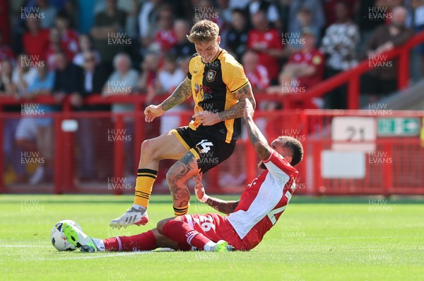 080825 - Crawley Town v Newport County, EFL Sky Bet League 2 - Kai Whitmore of Newport County is challenged by Jay Williams of Crawley Town
