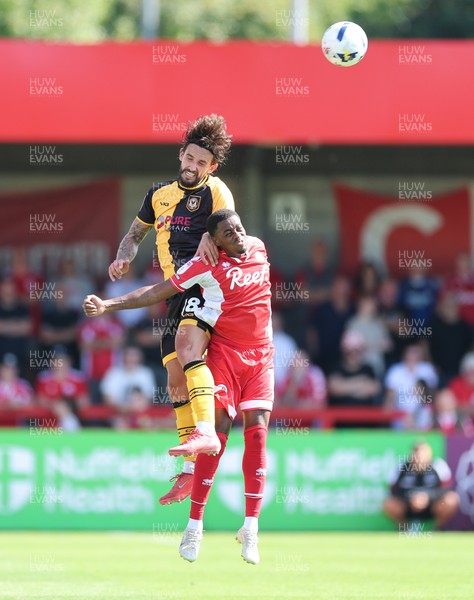 080825 - Crawley Town v Newport County, EFL Sky Bet League 2 - Liam Shephard of Newport County gets above Reece Brown of Crawley Town to head the ball