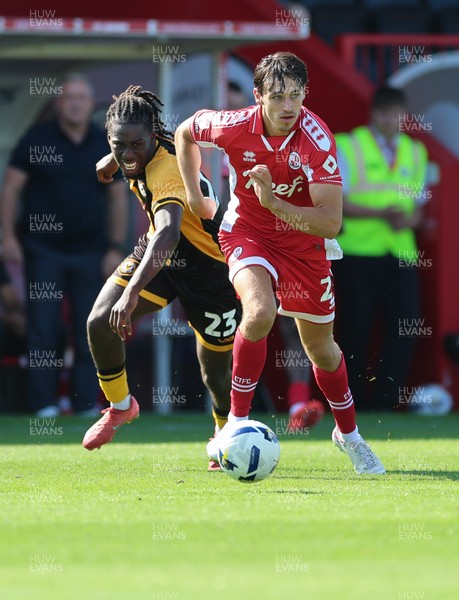080825 - Crawley Town v Newport County, EFL Sky Bet League 2 - Josh Flint of Crawley Town and Michael Reindorf of Newport County compete for the ball