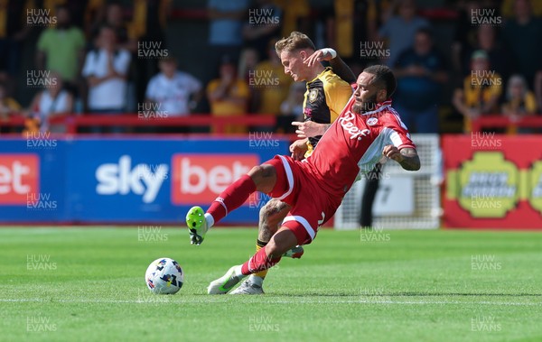 080825 - Crawley Town v Newport County, EFL Sky Bet League 2 - Kai Whitmore of Newport County is tackled by Jay Williams of Crawley Town