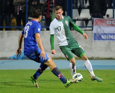 061012 - Croatia v Wales - World Cup QualifierWales' Simon Church is put under pressure by Gordon Schildenfeld of Croatia 