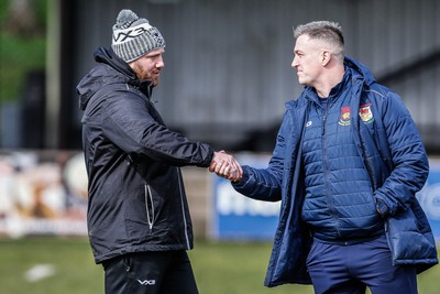 250323 - Cross Keys v Ystrad Rhondda - WRU Championship Cup Semi Final - Cross Keys Head Coach Morgan Stoddart and Ystrad Rhondda Head Coach Dylan Cynlais Jones shake hands before todays match