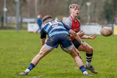 250323 - Cross Keys v Ystrad Rhondda - WRU Championship Cup Semi Final - McCauley Rowley of Ystrad Rhondda tackles Sam Berry of Cross Keys 