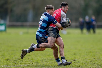 250323 - Cross Keys v Ystrad Rhondda - WRU Championship Cup Semi Final - McCauley Rowley of Ystrad Rhondda tackles Adam Tetley of Cross Keys 