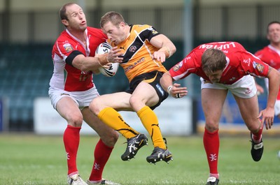 25.07.10.. Crusaders v Castleford Tigers, engage Super League -  Castleford's Michael Wainwright is tackled by Crusaders' Adam Peek and Peter Lupton  