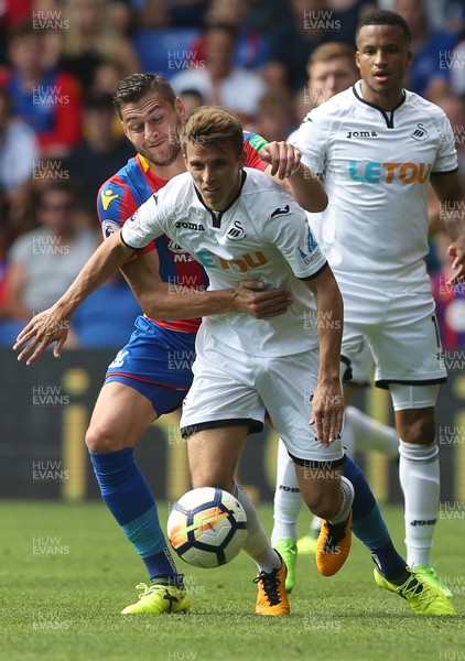 260817 - Crystal Palace v Swansea City - Premier League - Tom Carroll of Swansea City is pulled back by Joel Ward of Crystal Palace