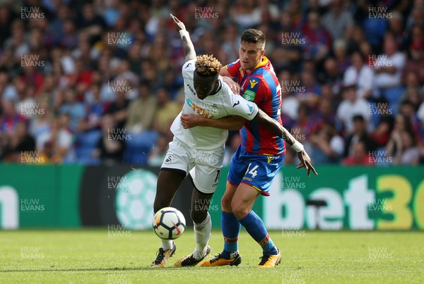 260817 - Crystal Palace v Swansea City - Premier League - Tammy Abraham of Swansea City is tackled by Martin Kelly of Crystal Palace