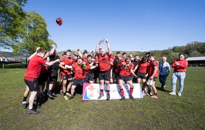 250426 - Cwmafan v Bryncoch, Admiral National League 3 West Central - Captain Ashley Mortimer lifts the trophy alongside team mates