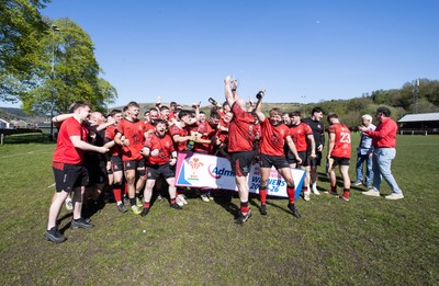 250426 - Cwmafan v Bryncoch, Admiral National League 3 West Central - Captain Ashley Mortimer lifts the trophy alongside team mates