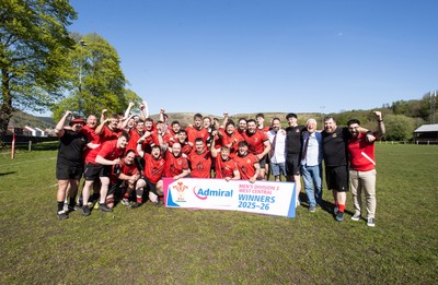 250426 - Cwmafan v Bryncoch, Admiral National League 3 West Central - Captain Ashley Mortimer lifts the trophy alongside team mates