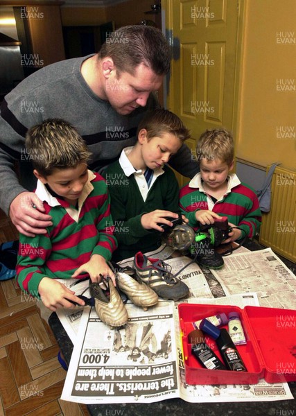 161101 - Dai Young -  Former Welsh rugby captain Dai Young watches as his sons l-r Lewis,Thomas and Owen clean their rugby boots