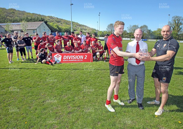 050518 - Denbigh v Llanidloes - WRU Division 2 North -  Denbigh celebrate winning the league Pictured: WRU Board Member Alwyn Jones presents the trophy to club captain Narmer EL-Lamie (right) and captain of the side during the game, Tom Seddon (left, in kit)  