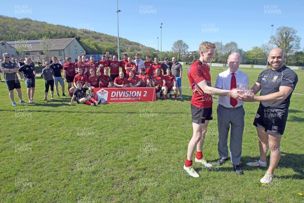 050518 - Denbigh v Llanidloes - WRU Division 2 North -  Denbigh celebrate winning the league Pictured: WRU Board Member Alwyn Jones presents the trophy to club captain Narmer EL-Lamie (right) and captain of the side during the game, Tom Seddon (left, in kit)  