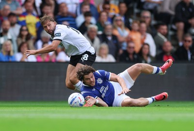 220826 - Derby County v Cardiff City, EFL Sky Bet Championship - Ollie Tanner of Cardiff City is brought down by Charlie Taylor of Derby County