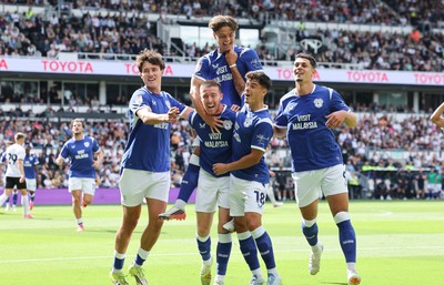 220826 - Derby County v Cardiff City, EFL Sky Bet Championship - Cian Ashford of Cardiff City celebrates on the shoulders of Jack Moylan of Cardiff City after scoring the first goal