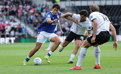 220826 - Derby County v Cardiff City, EFL Sky Bet Championship - Rubin Colwill of Cardiff City holds off Alex Mowatt of Derby County