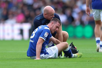 220826 - Derby County v Cardiff City, EFL Sky Bet Championship - Jack Moylan of Cardiff City receives treatment after taking a knock