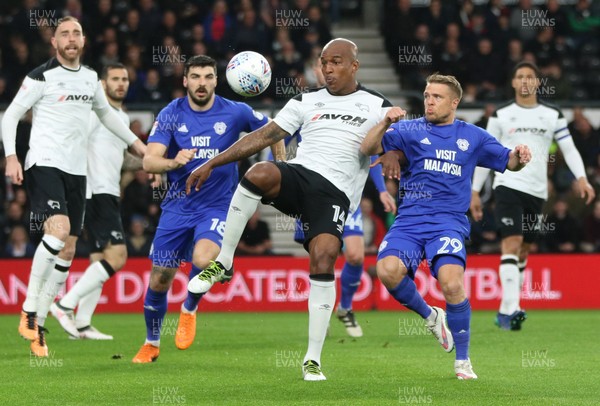 240418 - Derby County v Cardiff City, Sky Bet Championship - Andre Wisdom of Derby County and Jamie Ward of Cardiff City compete for the ball