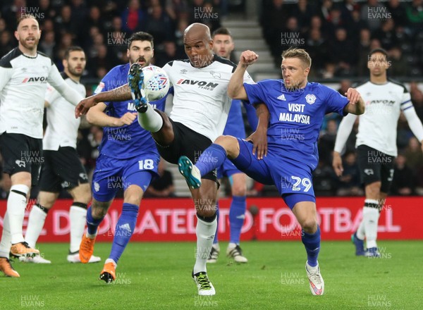 240418 - Derby County v Cardiff City, Sky Bet Championship - Andre Wisdom of Derby County and Jamie Ward of Cardiff City compete for the ball