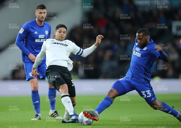 240418 - Derby County v Cardiff City, Sky Bet Championship - Junior Hoilett of Cardiff City challenges Curtis Davies of Derby County