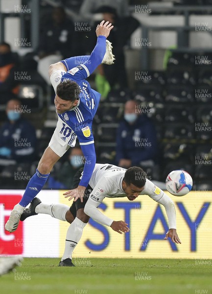 281020 - Derby County v Cardiff City - Sky Bet Championship - Kieffer Moore of Cardiff flies over Nathan Byrne of Derby to try a header for goal