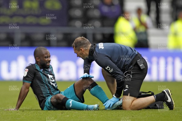 100819 - Derby County v Swansea City, Sky Bet Championship - Aldo Kalulu of Swansea City receives treatment after sustaining an injury