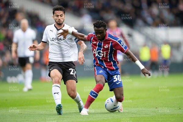 290826 - Derby County v Swansea City - Sky Bet Championship - Jospeh Opoku of Swansea City is challenged by Lewis Travis of Derby
