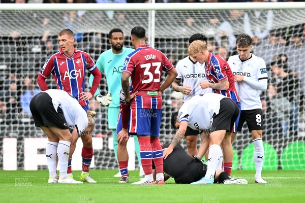 290826 - Derby County v Swansea City - Sky Bet Championship - Referee, David Webb is struck in the face by the ball