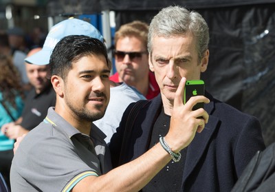 170714 - Doctor Who Filming, Cardiff - Doctor Who actor Peter Capaldi poses for a selfie with a fan after  filming in Cardiff City centre 