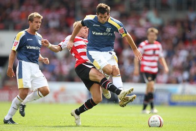 16.08.08...Doncaster Rovers v Cardiff City, Coca Cola Championship. -  Cardiff's Joe Ledley is tackled by Doncaster's James Coppinger   