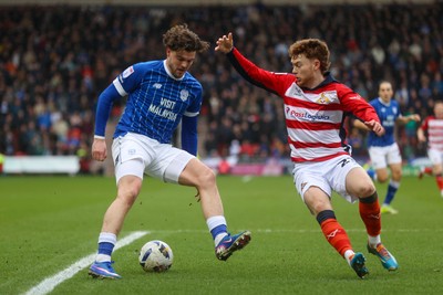 280226 - Doncaster Rovers v Cardiff City - Sky Bet League 1 - Ollie Tanner takes on the Doncaster defence 