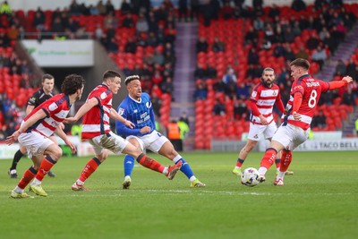 280226 - Doncaster Rovers v Cardiff City - Sky Bet League 1 - Callum Robinsion is pressured by Doncaster defenders 