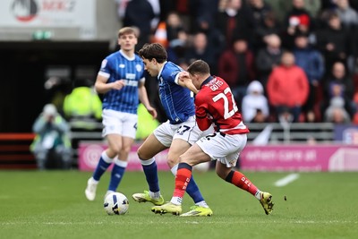 280226 - Doncaster Rovers v Cardiff City - Sky Bet League 1 - Jacob Colwill shields the ball from Robbie Gotts 
