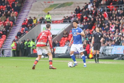280226 - Doncaster Rovers v Cardiff City - Sky Bet League 1 - Calum Scanlon looks for a way past Luke Molyneux