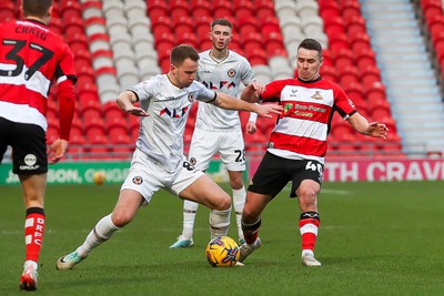 130124 - Doncaster Rovers v Newport County - Sky Bet League 2 - Bryn Morris and Billy Waters tussle for the ball 