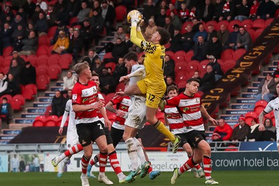 130124 - Doncaster Rovers v Newport County - Sky Bet League 2 - Ryan Delaney of Newport challenges Doncaster Goalkeeper Louis Jones 