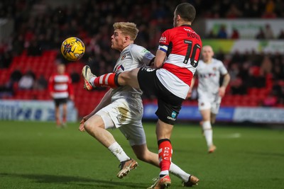 130124 - Doncaster Rovers v Newport County - Sky Bet League 2 - Will Evans of Newport reaches the ball ahead of a Doncaster defender