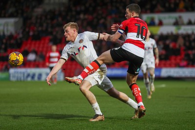 130124 - Doncaster Rovers v Newport County - Sky Bet League 2 - Will Evans of Newport lunges for the ball