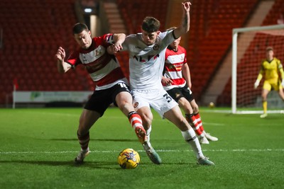 130124 - Doncaster Rovers v Newport County - Sky Bet League 2 - Seb Palmer-Houlden of Newport fights for the ball