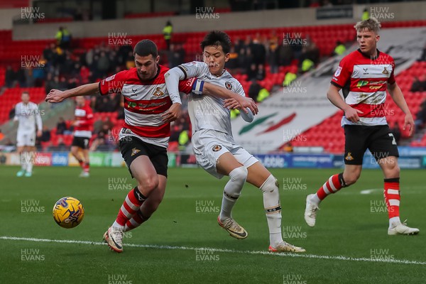 130124 - Doncaster Rovers v Newport County - Sky Bet League 2 - Kiban Rai and Tommy Rowe tussle for the ball 