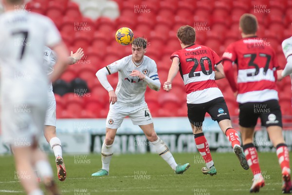 130124 - Doncaster Rovers v Newport County - Sky Bet League 2 - Ryan Delaney of Newport heads clear 